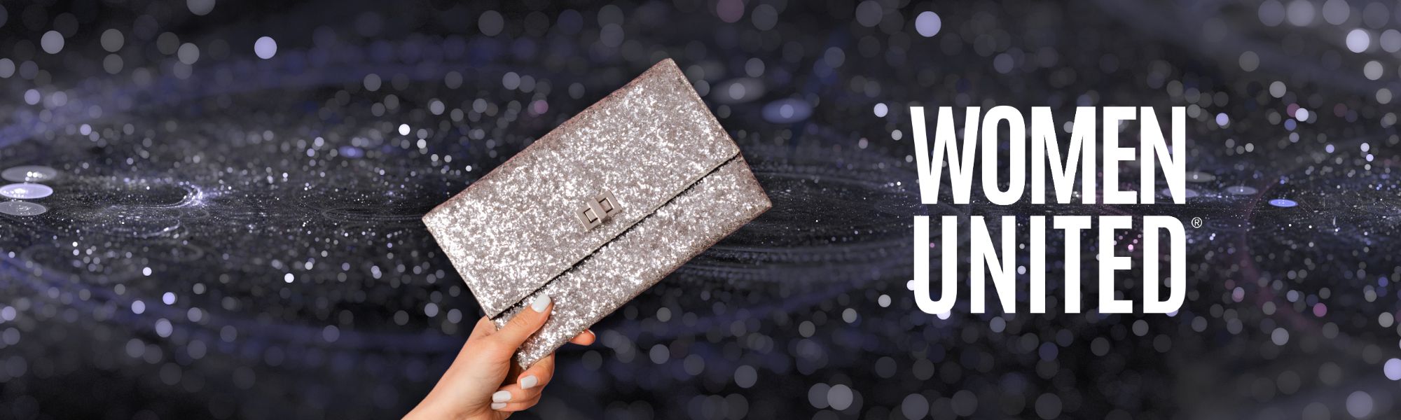 Woman's arm holding a silver clutch purse