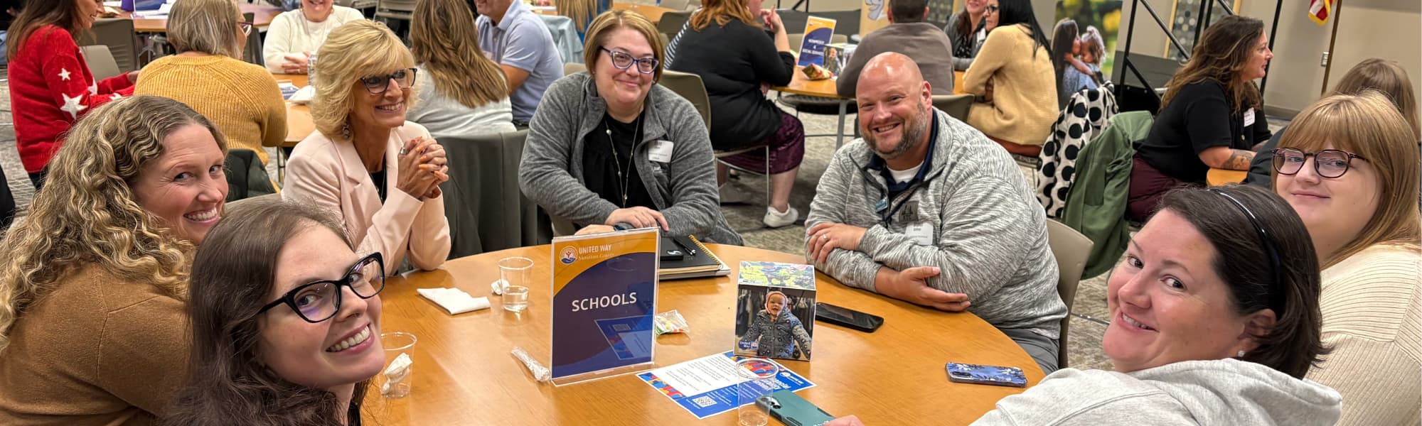 People at a table discussing education 