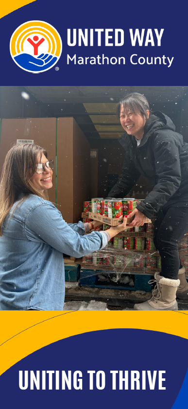 Two woman unloading food from a truck