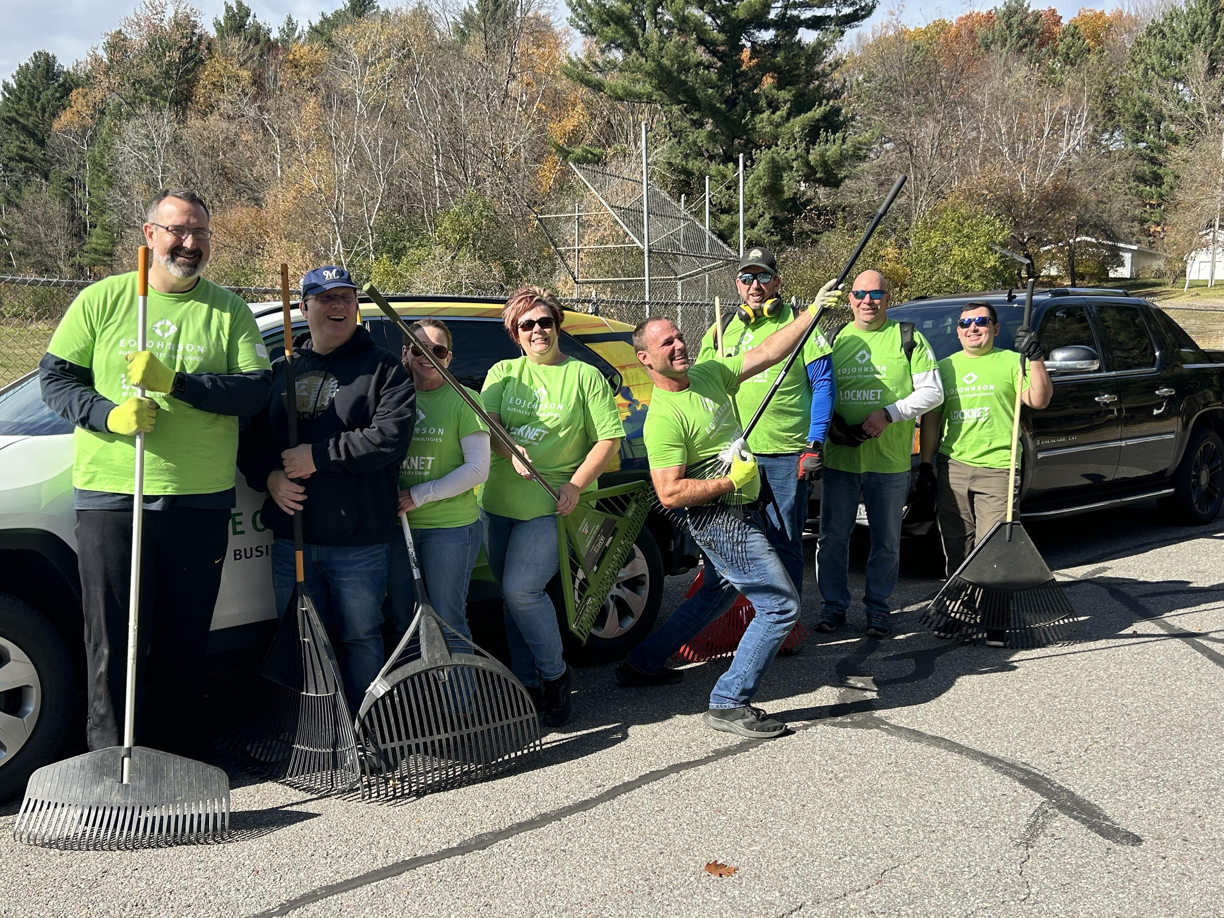 Group of people holding rakes 