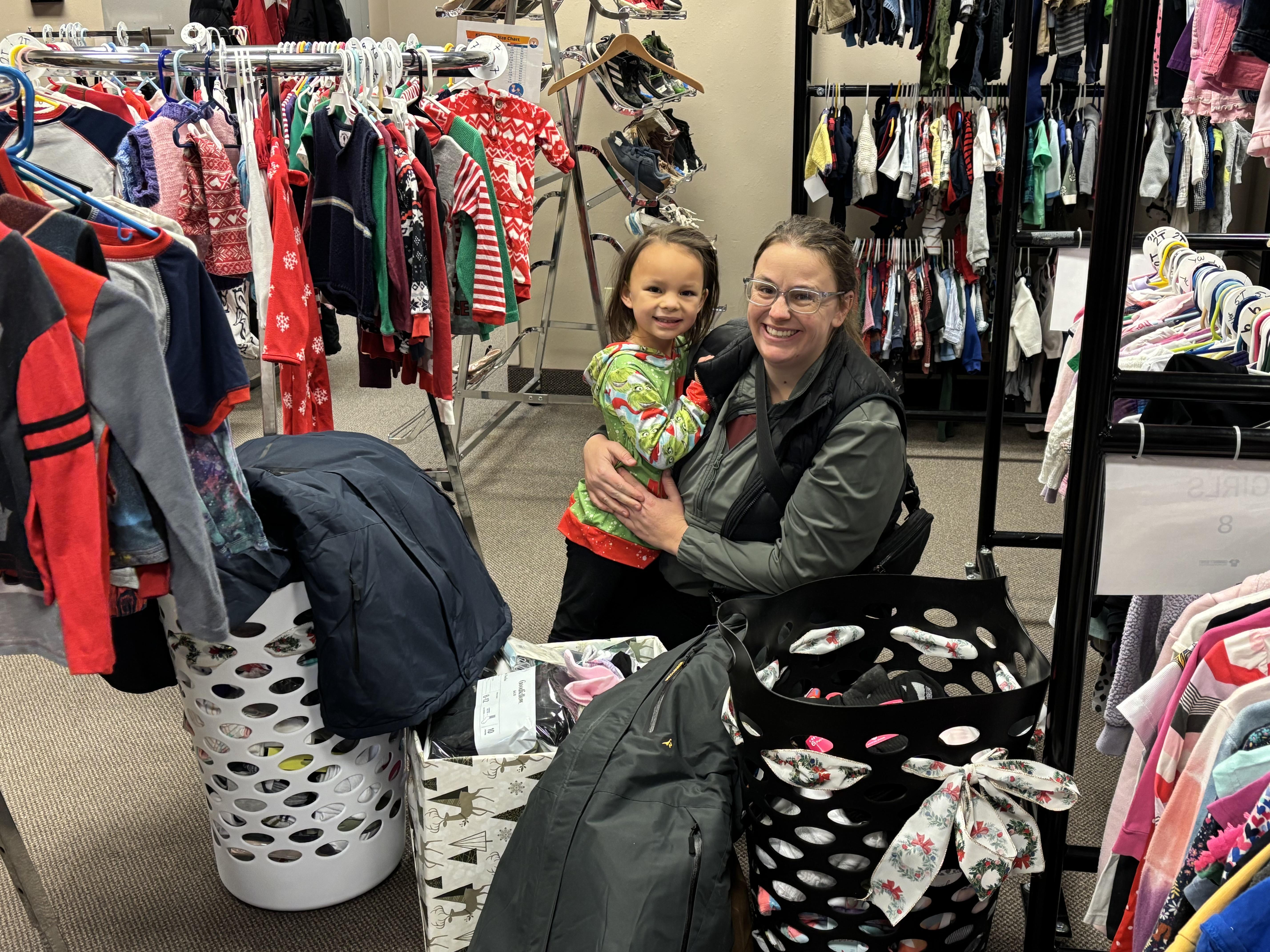 Woman and daughter donating clothes 