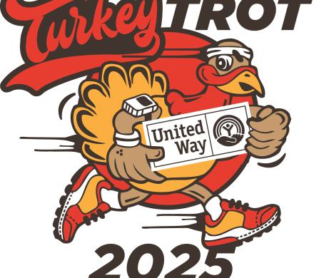 Turkey holding a United Way sign and has sneakers on