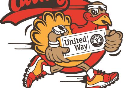 Turkey holding a United Way sign and has sneakers on