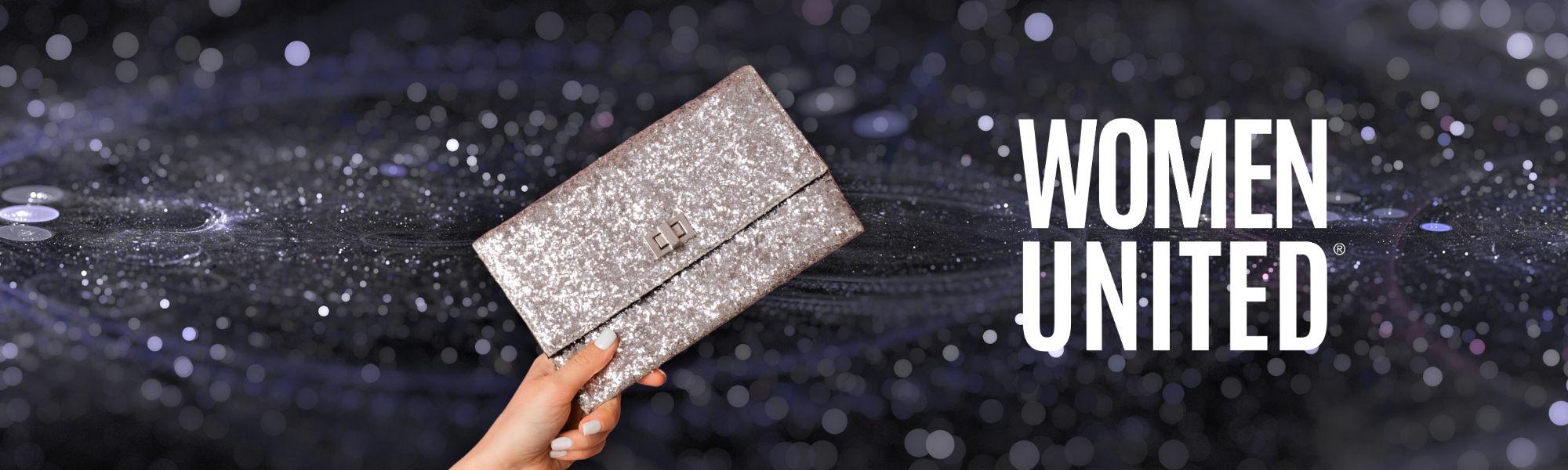 Woman's arm holding a silver clutch purse