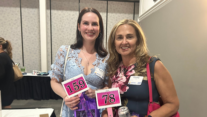 Women holding bid paddles 