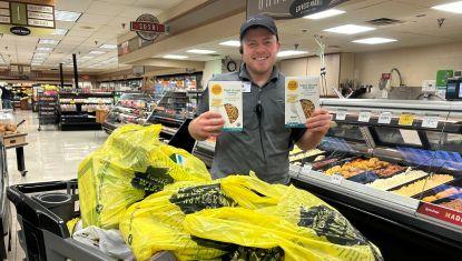 Man holding two boxes of pasta 
